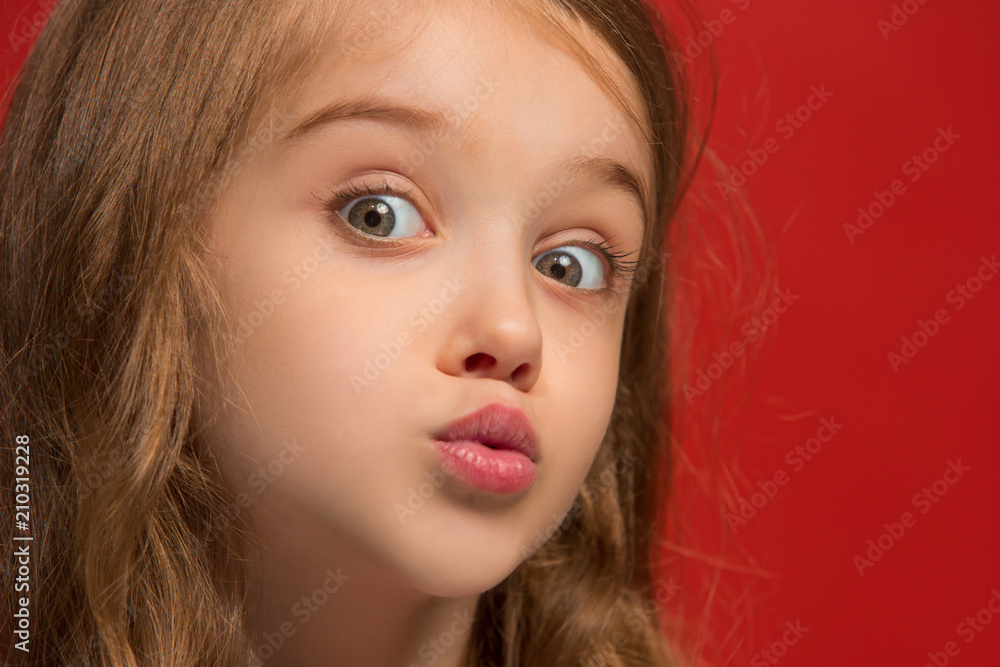 Beautiful teen girl looking suprised isolated on red Beautiful teen girl looking suprised isolated on red