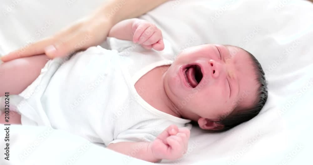Baby new born baby crying with mother comforting Baby new born baby crying with mother comforting