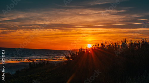 Fototapeta Naklejka Na Ścianę i Meble -  orange sunset in Tarifa with the sea at the back