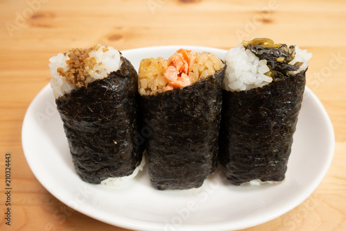 Various types of traditional Japanese rice balls, called Onigiri, wrapped with seaweed.