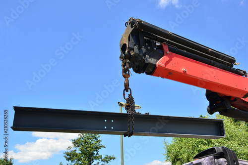 A crane lifting a piece of steel. 