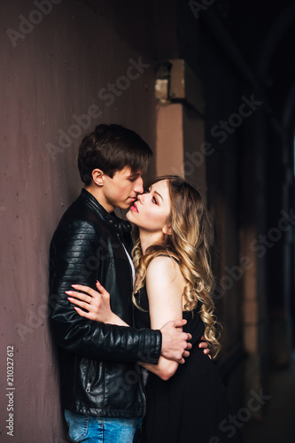 Young beautiful couple in love hugging and kissing on the street city