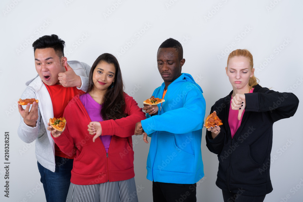 Studio shot of diverse group of multi ethnic friends giving thum Studio shot of diverse group of multi ethnic friends giving thum