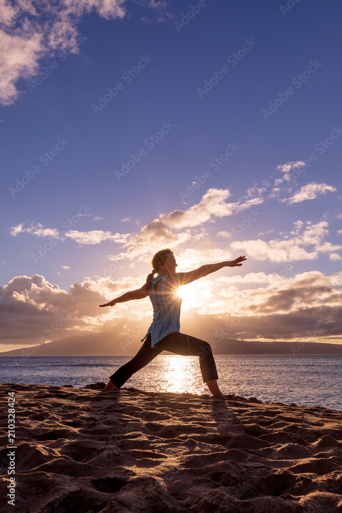 Woman Practicing Yoga on a Maui Beach at Susnet