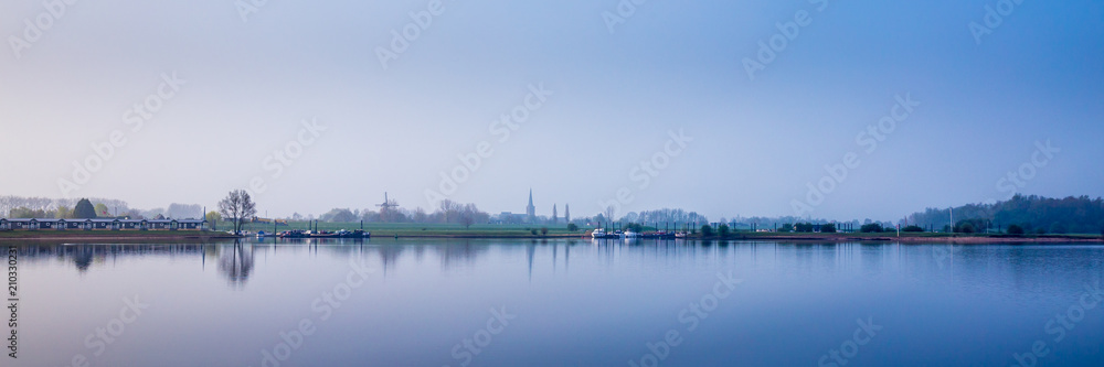Obraz premium Dutch river landscape during blue hour. View from the Island of Maurik in Gelderland, Netehralds