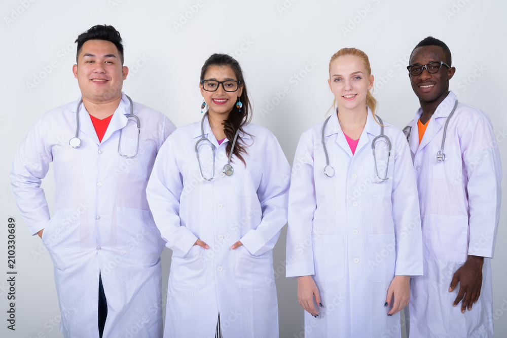Studio shot of happy diverse group of multi ethnic doctors smili Studio shot of happy diverse group of multi ethnic doctors smili