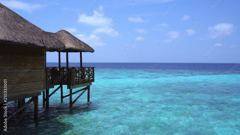 Tropical travel destination with pristine beach and water bungalows Tropical travel destination with pristine beach and water bungalows
