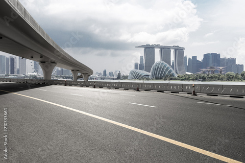 asphalt road with city skyline