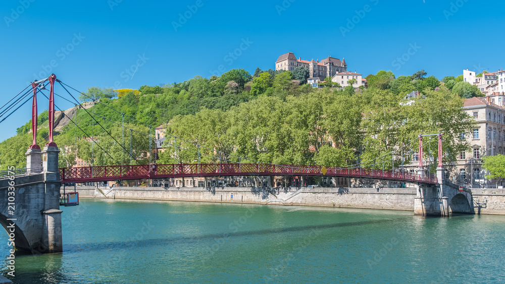 Vieux-Lyon, Saint-Georges footbridge, colorful houses and footbridge in the center, on the river Saone 
