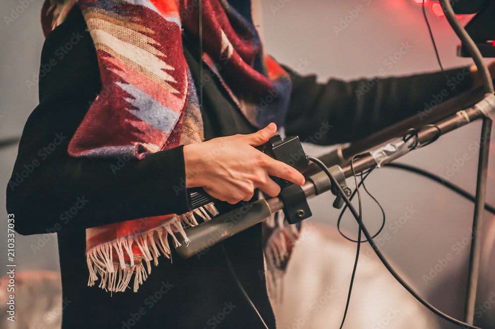 Fototapeta premium Behind the scene. Female cameraman shooting film scene with camera