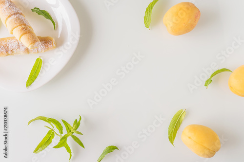 Tubules with cream, mint and apricots on a white background