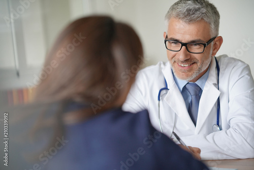 Doctor with patient in clinic room