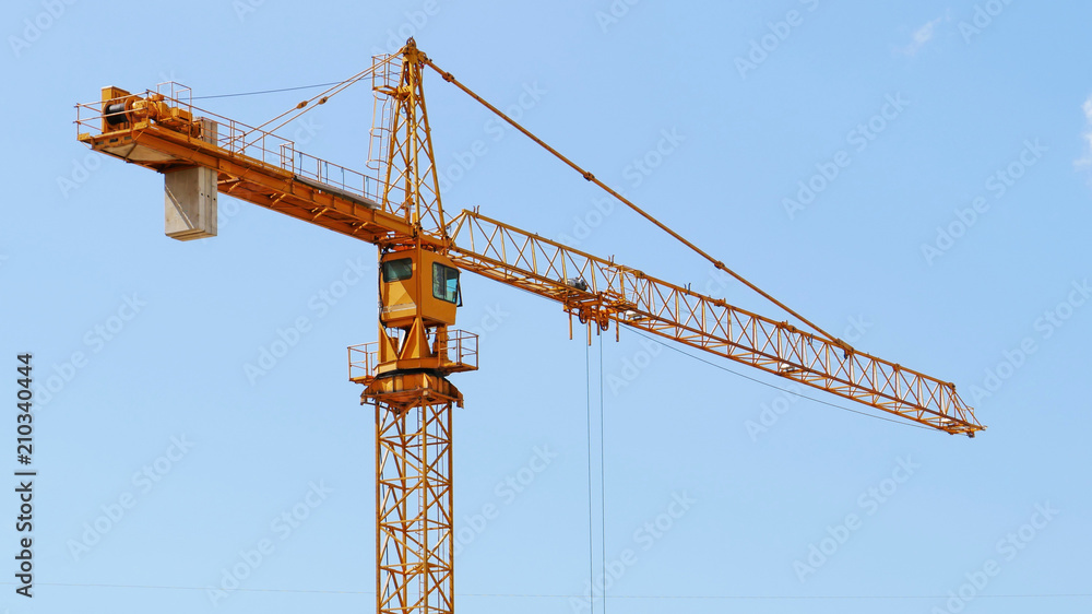 Construction crane against blue sky. Construction crane against blue sky.