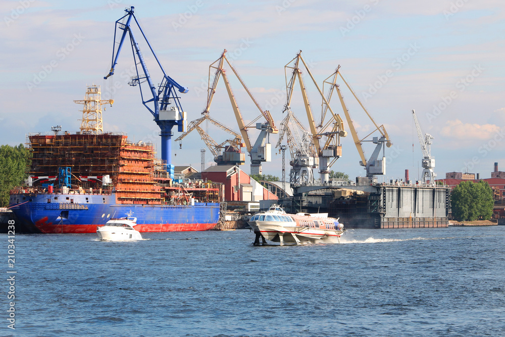 seaport with cranes, ships and boats