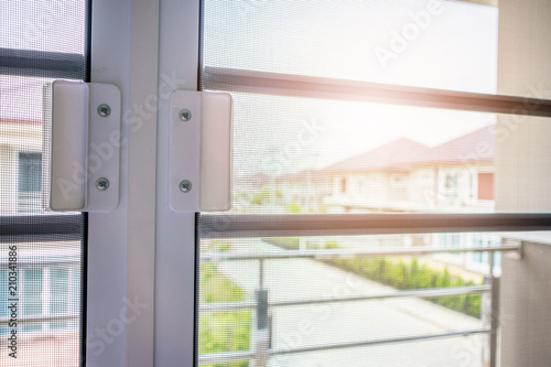 mosquito net wire screen on house window protection against insect © Piman Khrutmuang