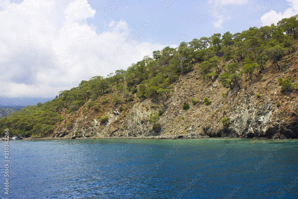Naklejka premium Calm Mediterranean Sea and mountains with green trees in Antalya