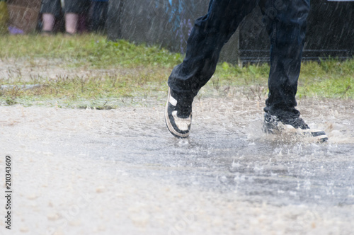 Leg shot sunning through puddle in the rain