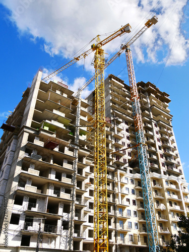 Two construction cranes near building. Construction site.