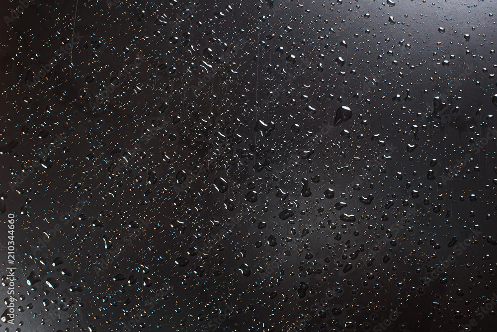A waterdrops on black surface, background A waterdrops on black surface, background