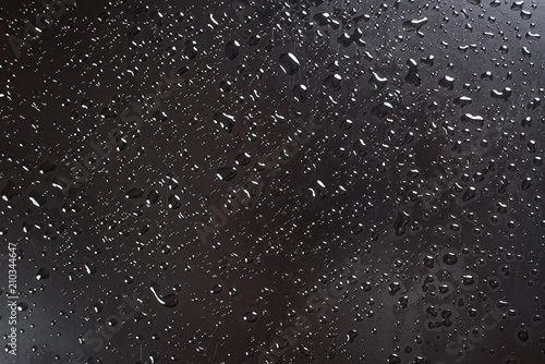 A waterdrops on black surface, background photo