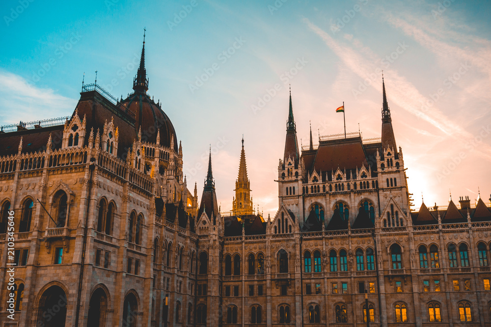 beautiful parliament of hungary with warm sunlight behind the towers