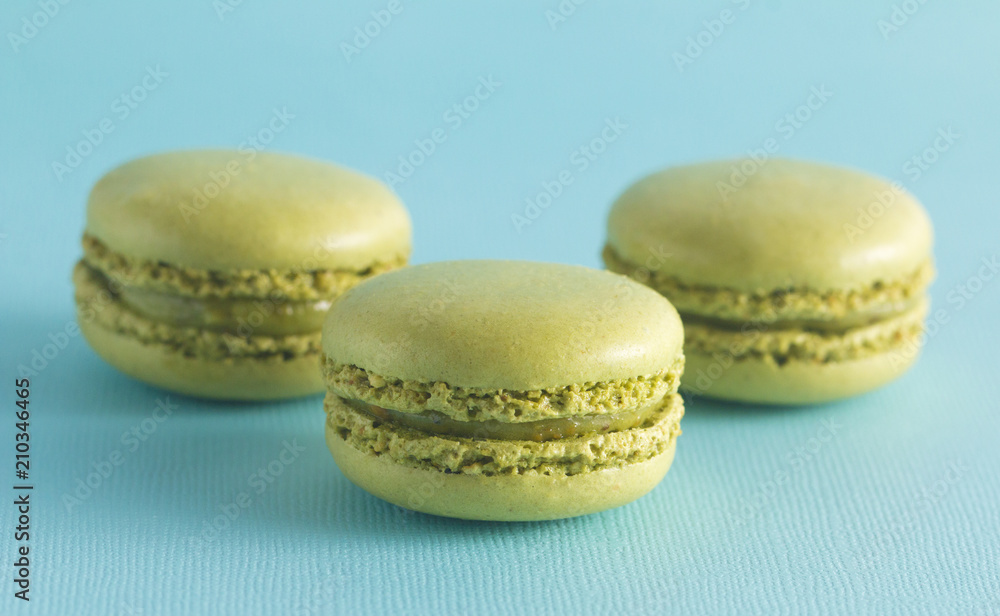 Green French Macarons on a Blue Background Green French Macarons on a Blue Background
