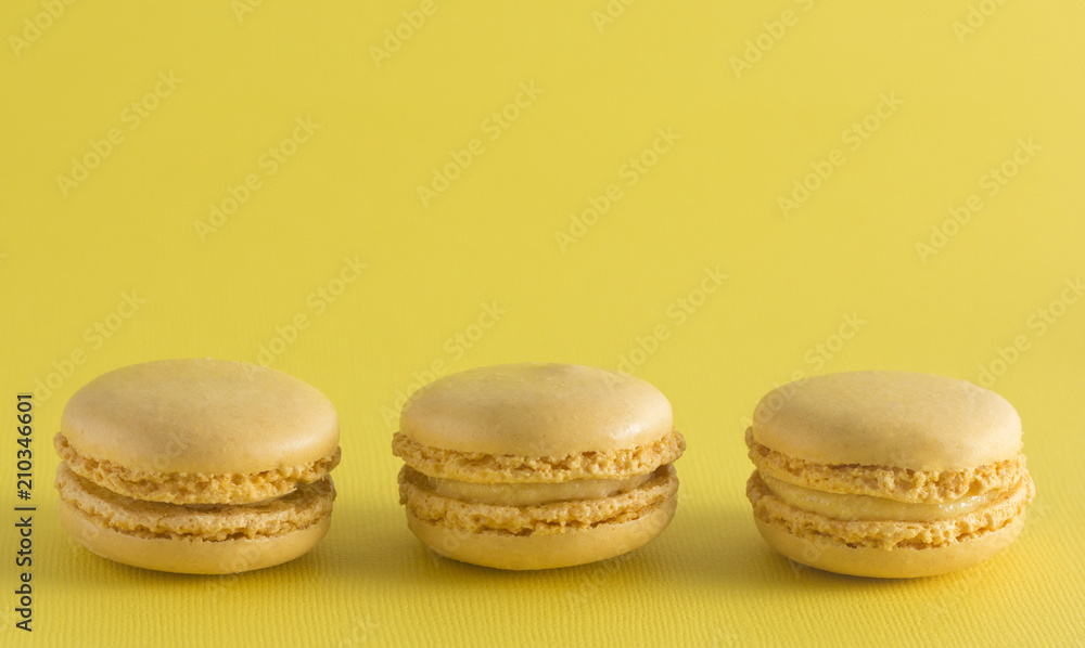 Yellow French Macarons on a Yellow Background Yellow French Macarons on a Yellow Background