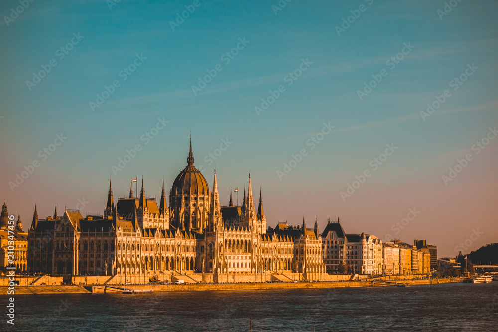 warm colored parliament of budapest in the afternoon with big copy space in the sky