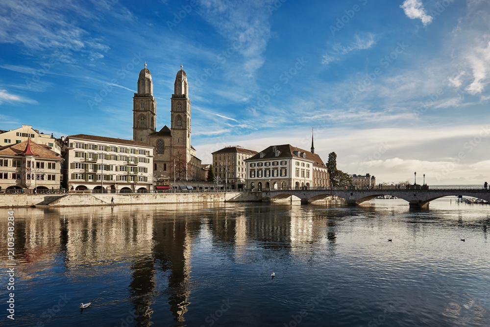 View of historic city of Zurich. Grossmunster Church and Munsterbucke crossing river Limmat, Canton of Zurich, Switzerland