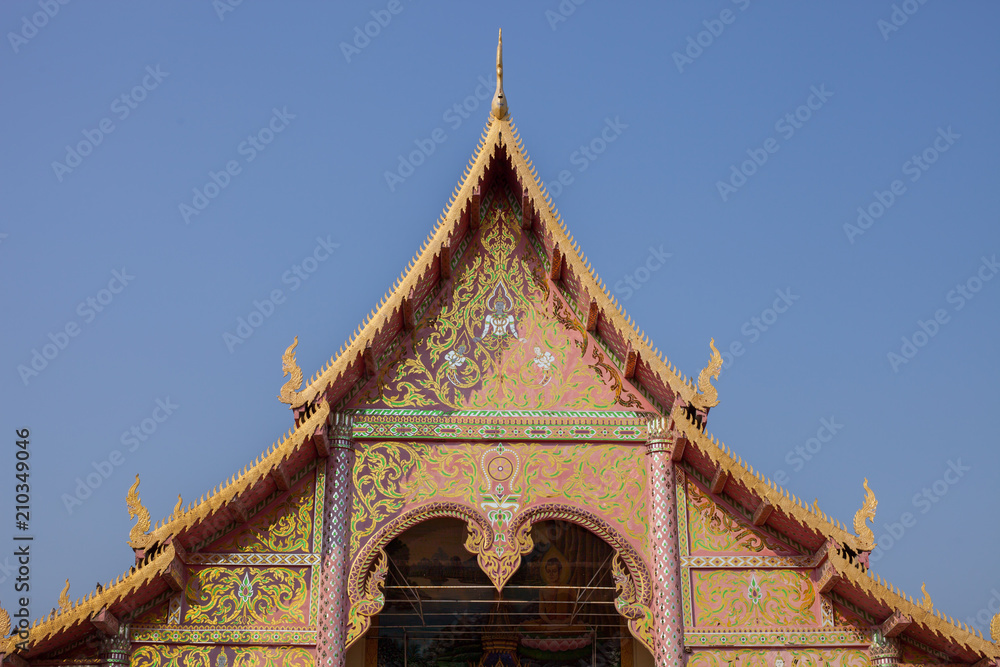 Thai stye temple in front of old wooden door.