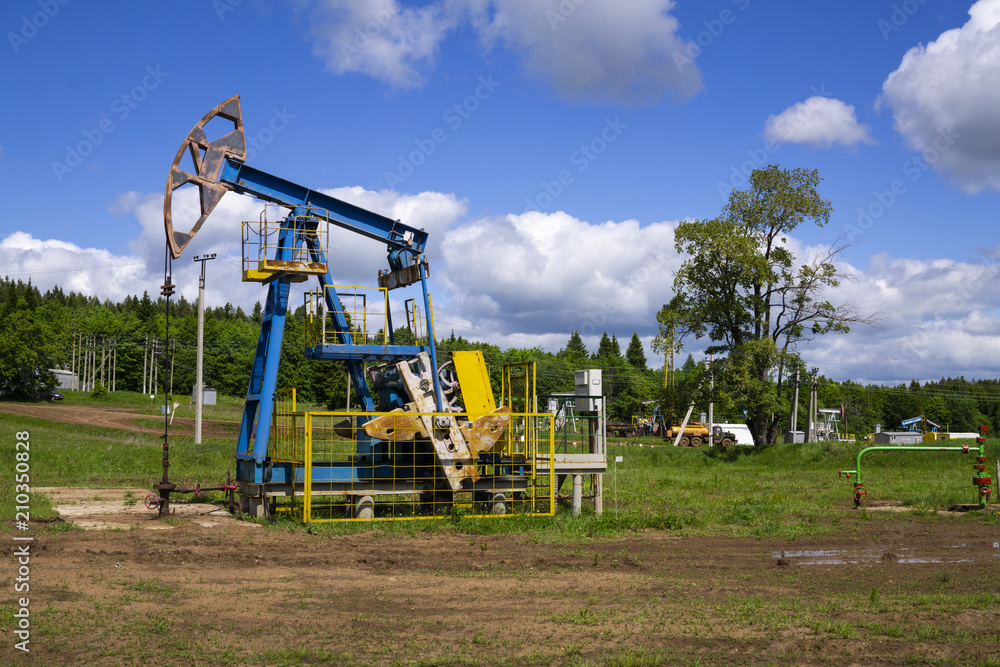 The beam pumping unit is homework, sunset in oil field. Oil pump oil rig energy industrial machine for petroleum. The pumping unit as the pump installed on a well. Equipment of oil fields. The beam pumping unit is homework, sunset in oil field. Oil pump oil rig energy industrial machine for petroleum. The pumping unit as the pump installed on a well. Equipment of oil fields.