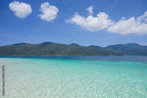 Fototapeta Naklejka Na Ścianę i Meble -  White sand beach with moutain under clear sky at ocean in Tropicana located at south of Thailand 