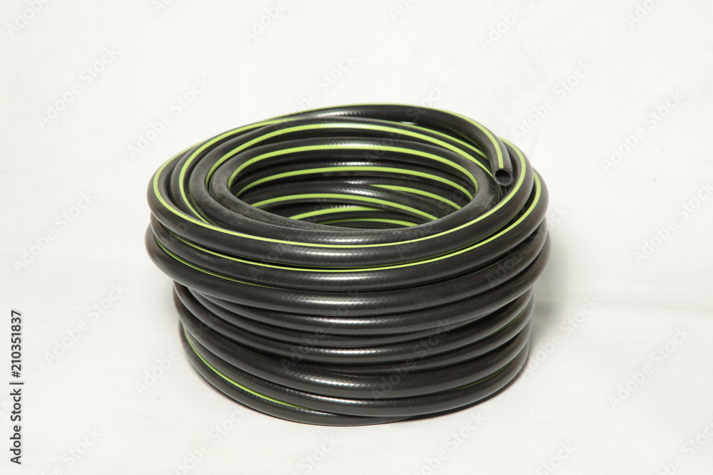 curled plastic garden water hose (pipe) isolated on white curled plastic garden water hose (pipe) isolated on white