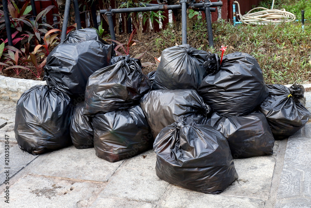 Garbage bags. Waste, black garbage bags plastic pile stack. Lots pile of garbage  bags stack. by KYNA STUDIO. Photo stock - StudioNow