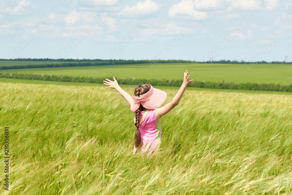 child walking through the wheat field, bright sun, beautiful summer landscape child walking through the wheat field, bright sun, beautiful summer landscape