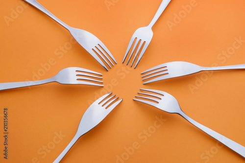 Six forks on orange
