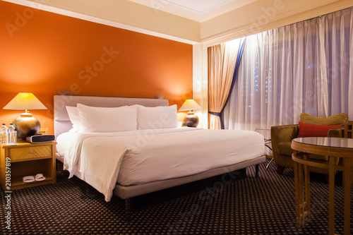 Interior superior bedroom at hotel with white bed and pillow