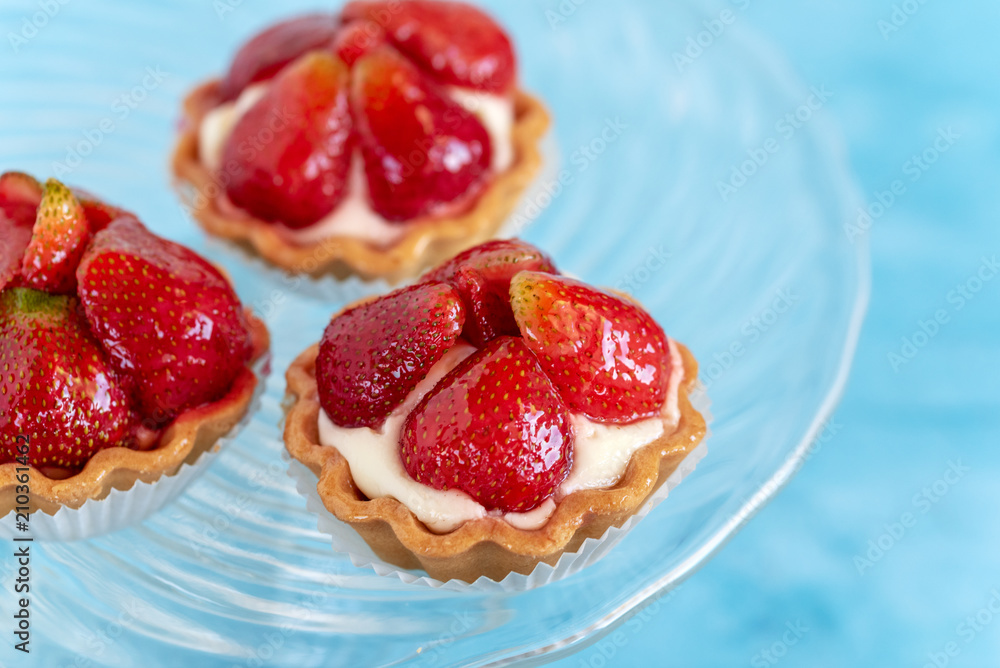 Tartlets with strawberries and cream. Dessert with fresh fruits. Tartlets with strawberries and cream. Dessert with fresh fruits.