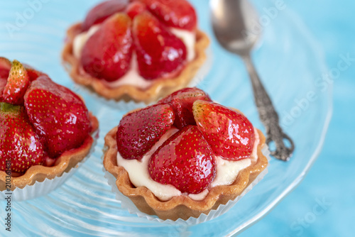 Tartlets with strawberries and cream. Dessert with fresh fruits.