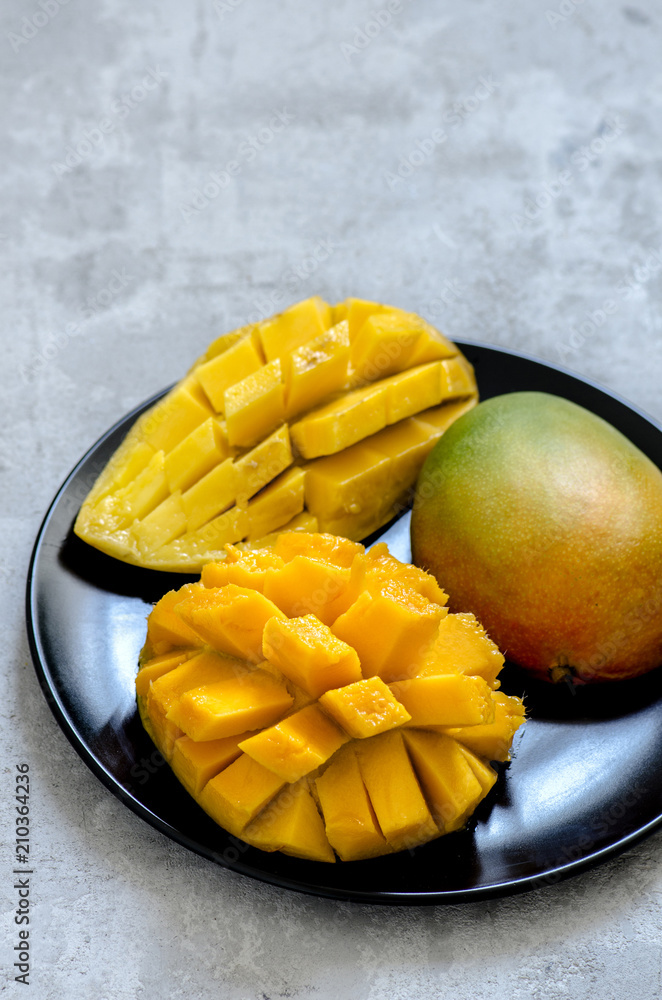Fresh juicy mango cut on a plate