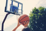 Playing game of basketball, shooting ball into basket.