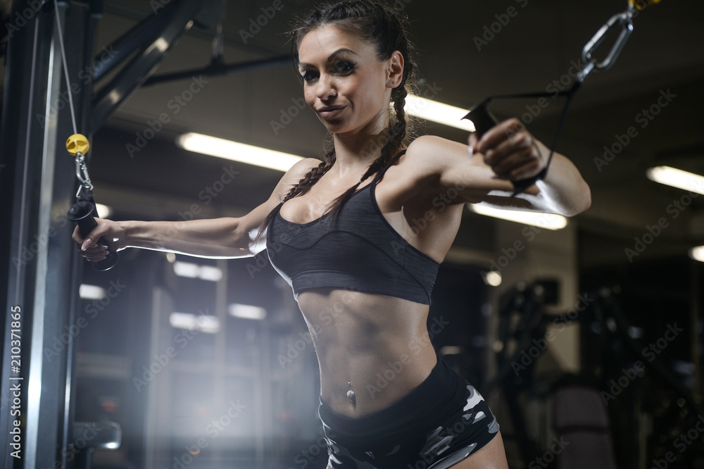 brunette sexy athletic young girl working out in gym brunette sexy athletic young girl working out in gym