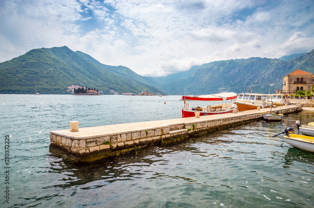 Beautiful mediterranean landscape. Mountains and fishing boats near town Perast, Kotor bay (Boka Kotorska), Montenegro.