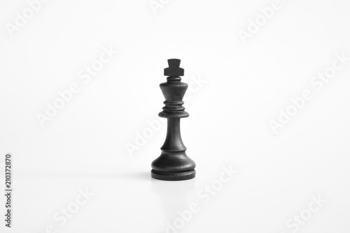 Black king chess piece in white isolated background