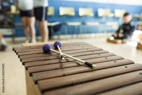 xylophone and drumsticks in a music class with children
