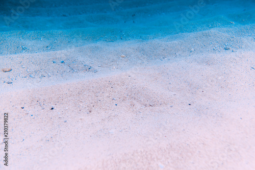 Water with sand is underwater. Sea texture in ocean.