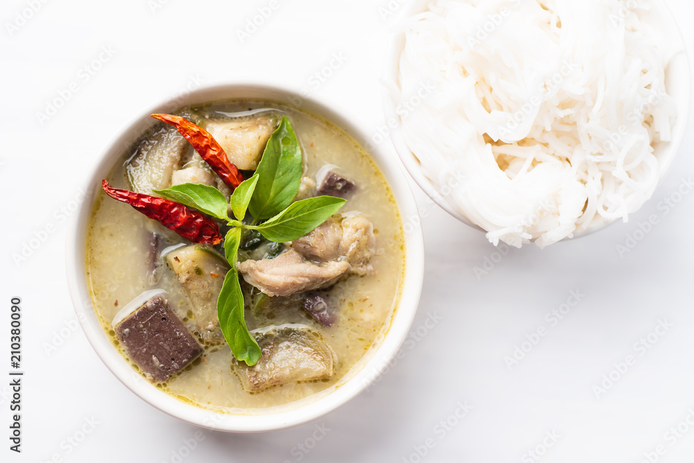 Green curry chicken (Kang Keaw Wan Gai) in a bowl and rice noodles, top view, Thai food Green curry chicken (Kang Keaw Wan Gai) in a bowl and rice noodles, top view, Thai food