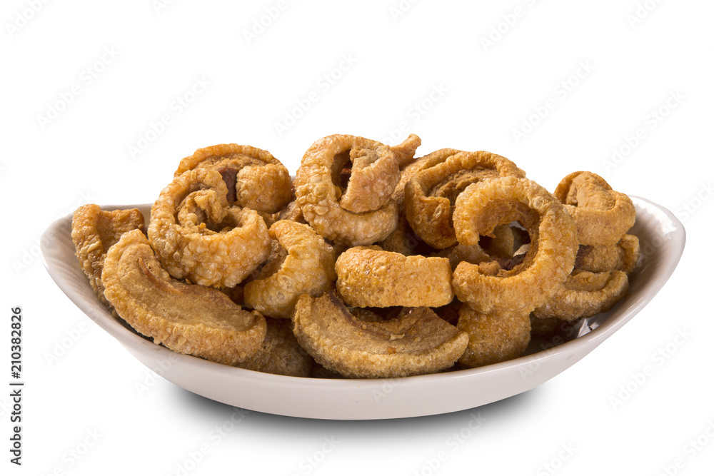 Pile of fried bacon cube portion in a white plate isolated. Pile of fried bacon cube portion in a white plate isolated.