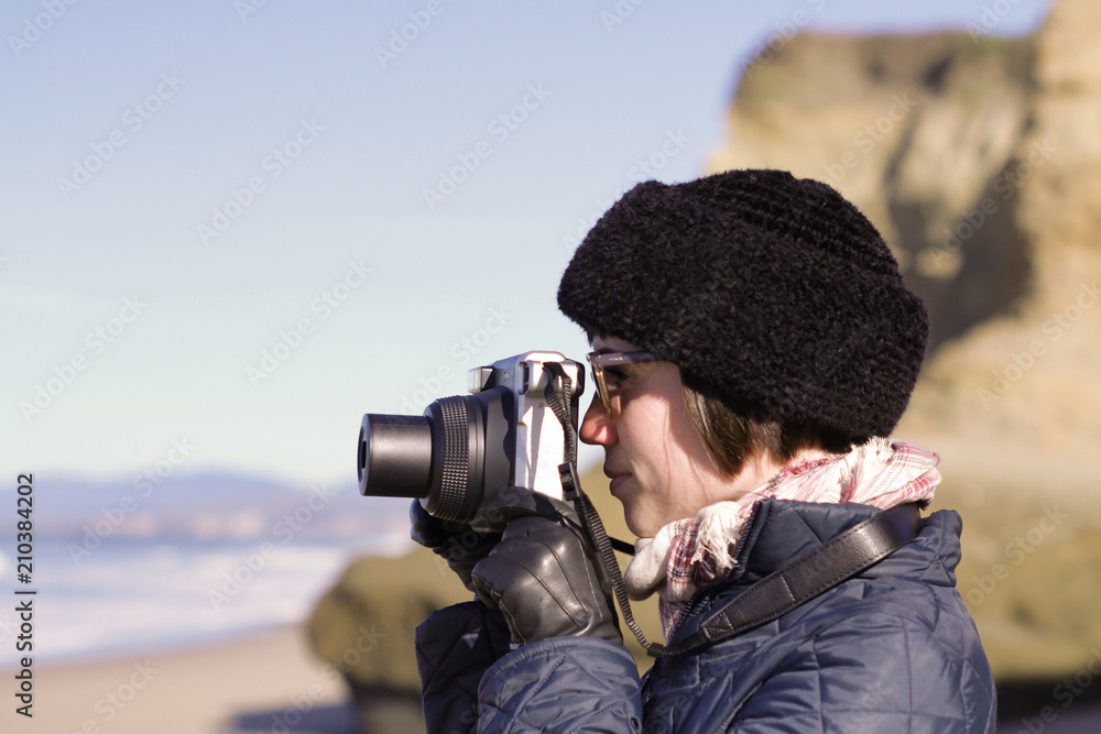 Woman shooting with instant film camera Woman shooting with instant film camera