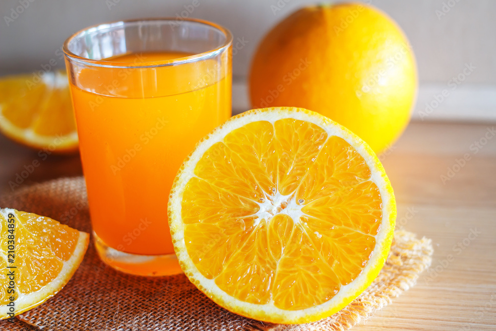 Orange and orange juice on wooden background Orange and orange juice on wooden background